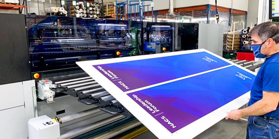 Employee inspecting the quality of a color matched print