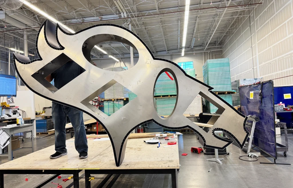 A bare metal frame in the shape of the Denver Broncos logo.