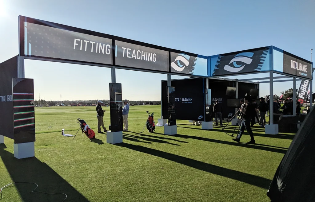 An outdoor booth made using a mesh fabric.
