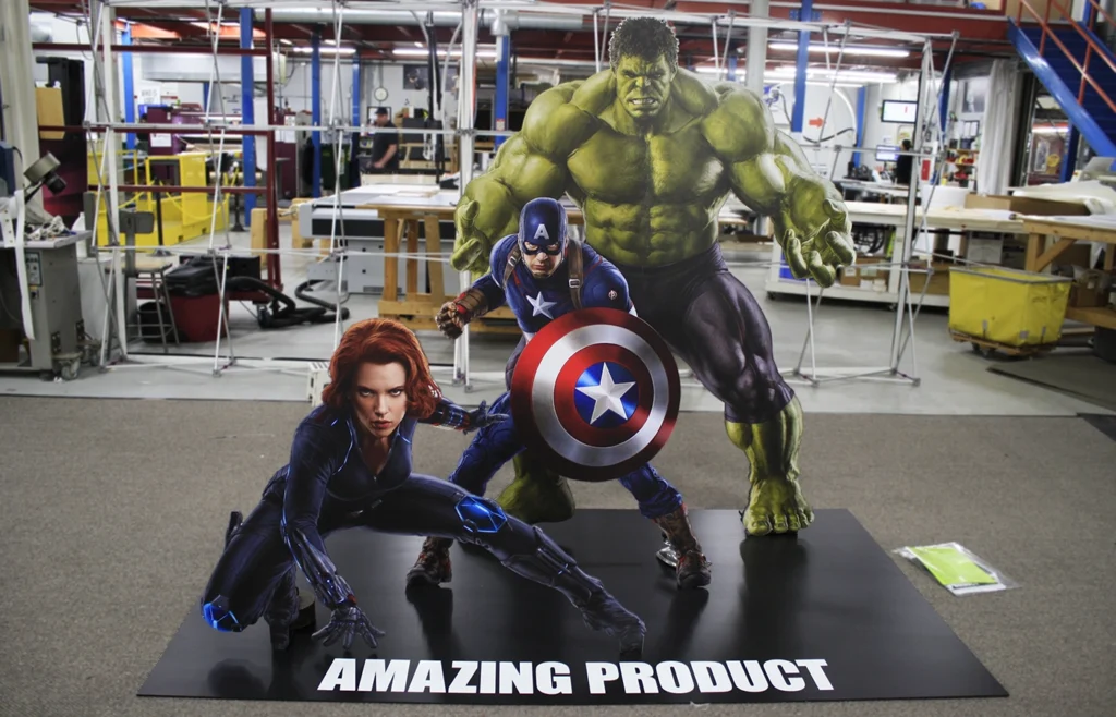 A cutout of the Avengers on a rigid board in a warehouse.